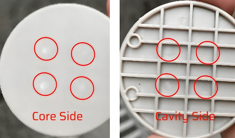 Close-up of a circular ejector pin mark left on a molded surface before the tooling and process fix